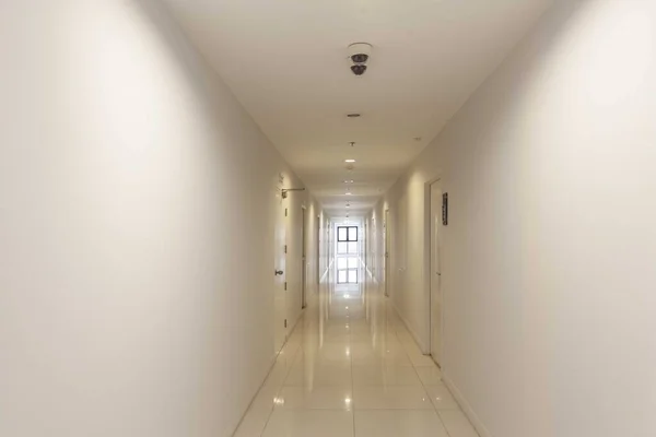 Long corridor between rooms at modern condominiums