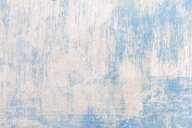 Pastel mavi renkli, eski alçı bir duvar ve pürüzsüz bir arka plan.