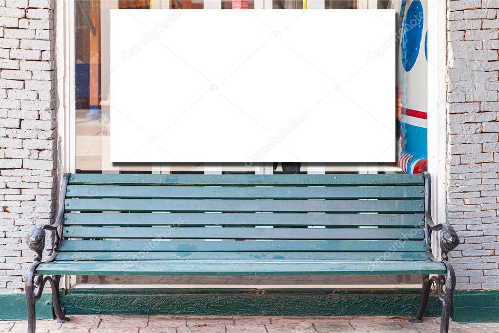 A blank billboard next to the waiting bench