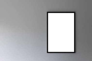 Pürüzsüz gri bir duvarda boş beyaz fotoğraf çerçevesi