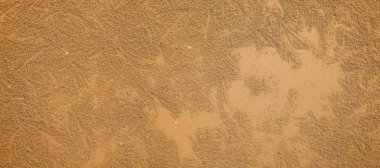 Arkaplan olarak kullanılmak üzere temiz kahverengi kum manzarası