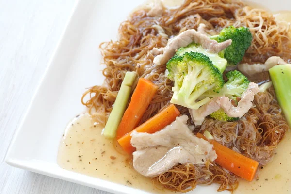 Fried noodle in gravy with pork — Stock Photo, Image