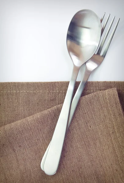 Fork and spoon on tablecloth — Stock Photo, Image