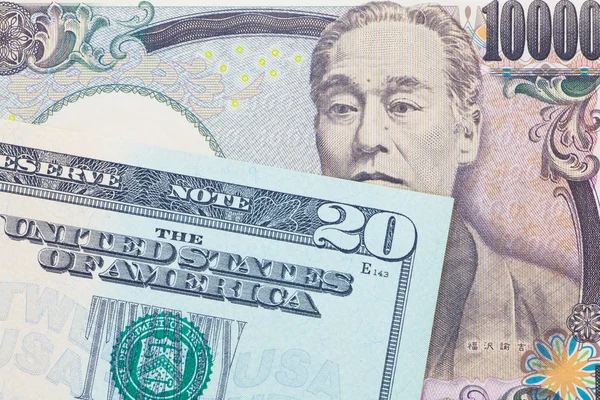 Moneda del yen japonés y billetes en dólares —  Fotos de Stock