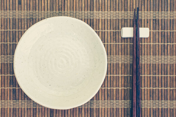 White ceramic plate and wood chopsticks