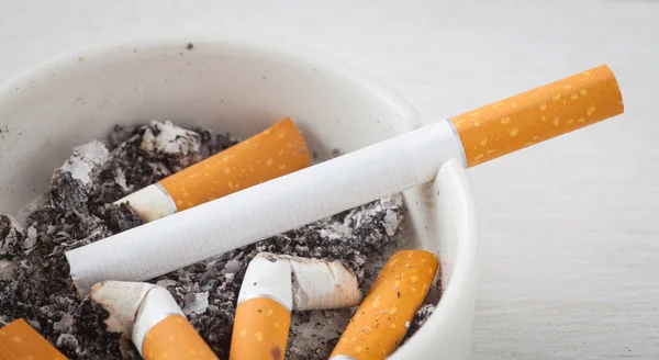 White ashtray with cigarettes — Stock Photo, Image