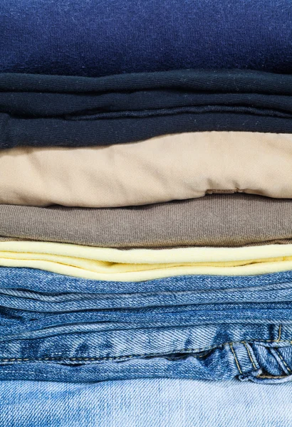 Stack of cotton shirts and jeans — Stock Photo, Image