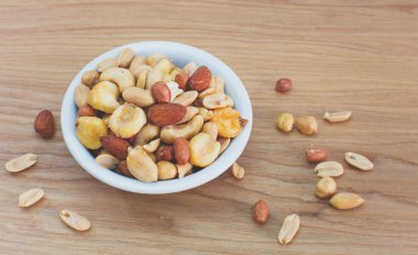 Mixed nuts in small bowl clipart