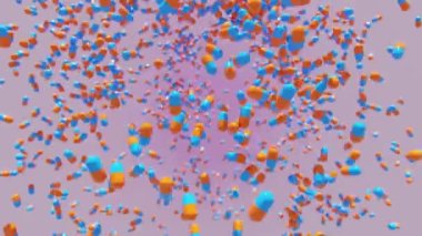 Pembe arka planda mavi ve turuncu tıbbi kapsül haplarının düşüşü.