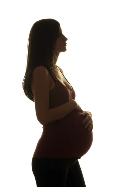 Silhouette einer schönen schwangeren Frau — Stockfoto