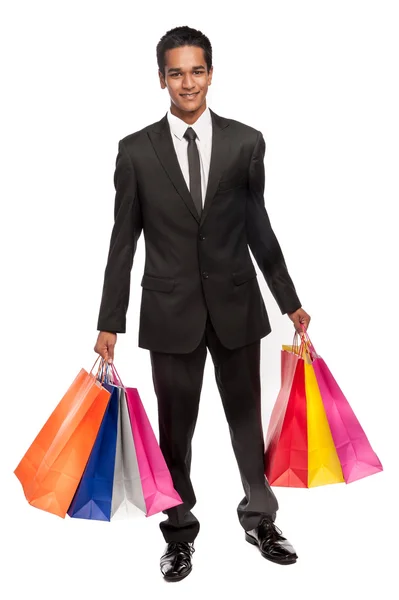 Joven hombre de raza mixta con bolsas de compras . — Foto de Stock