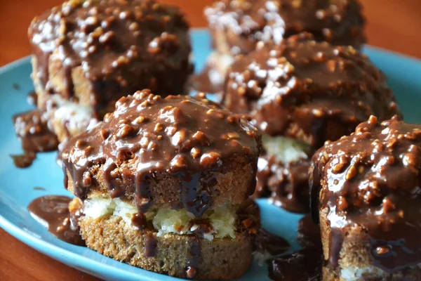 Home baked cocoa muffins with chocolate-peanut topping, selective focus