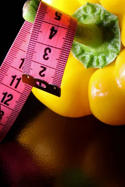 close-up yellow pepper and measure tape