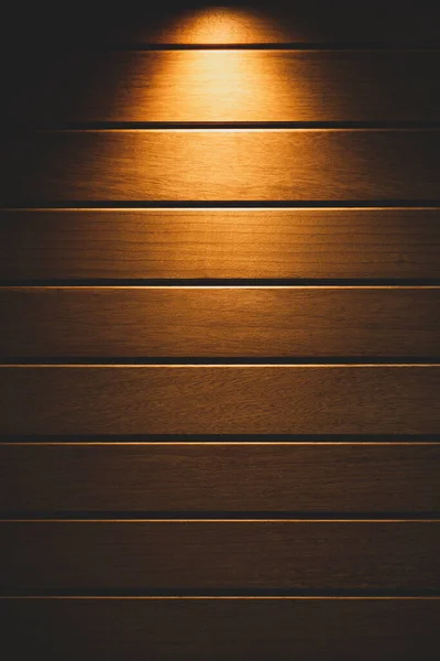 Sarı ışık yukarıdan ahşap zeminden yayılıyor, boşluğu kopyala