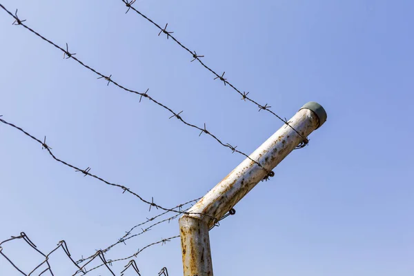 A building fence surrounded by barbed wires