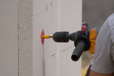 Tuğlacı çalışıyor. Havalandırmalı betondan bir duvar inşa etmek. Gasbeton duvarı