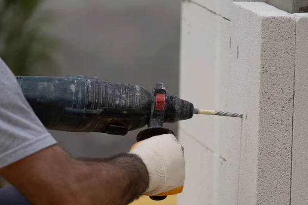 Tuğlacı çalışıyor. Havalandırmalı betondan bir duvar inşa etmek. Gasbeton duvarı