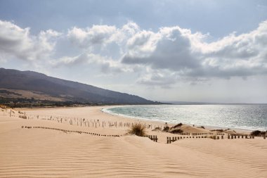 View of Valdevaqueros dune and beach in Tarifa. Natural landscape of the Cadiz coast in Andalusia, Spain clipart