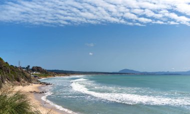 Picturesque scenery of waving sea and sandy Los Lances beach under blue sky with cirrocumulus clouds in Tarifa summer. Cadiz coastline, Andalusia, Spain clipart
