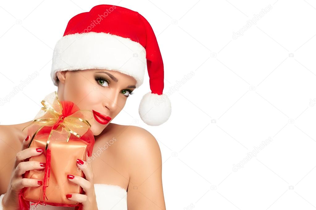 Happy Christmas Girl in Santa Hat hold a Gift in Hands