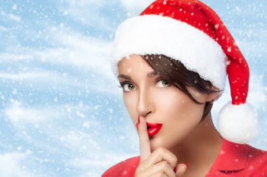Noel kız Noel Baba şapkası sus işareti yapıyor. Moda Noel