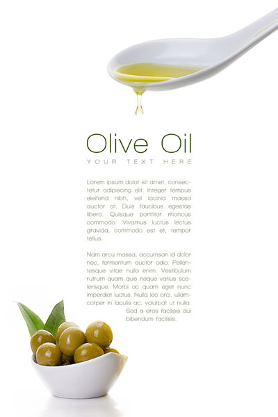 Virgin olive oil dripping from a spoon and olive seeds