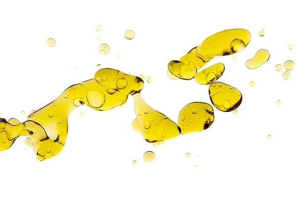 Azeite. Blobs abstratos de óleo dourado flutuando na água — Fotografia de Stock