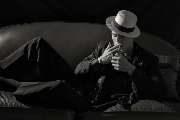 スタイリッシュな喫煙者。ファッショナブルな若い男がタバコの照明 — ストック写真