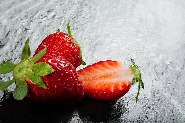Ripe red strawberries on a slate background — Stock Photo, Image