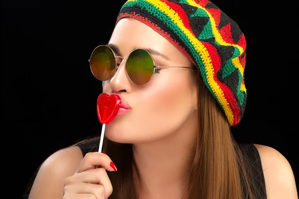 Stylish Young Woman Kissing a Heart Shaped Lollipop — Stock Photo, Image