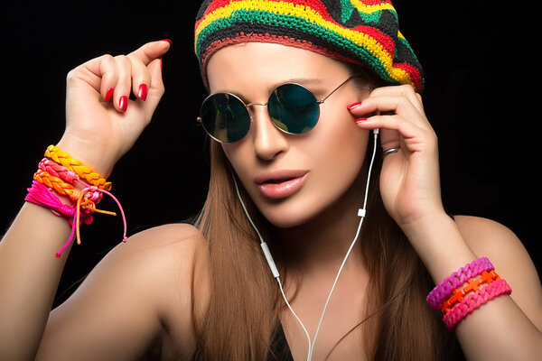Fashionable Young Woman Enjoying Music Through Headphone