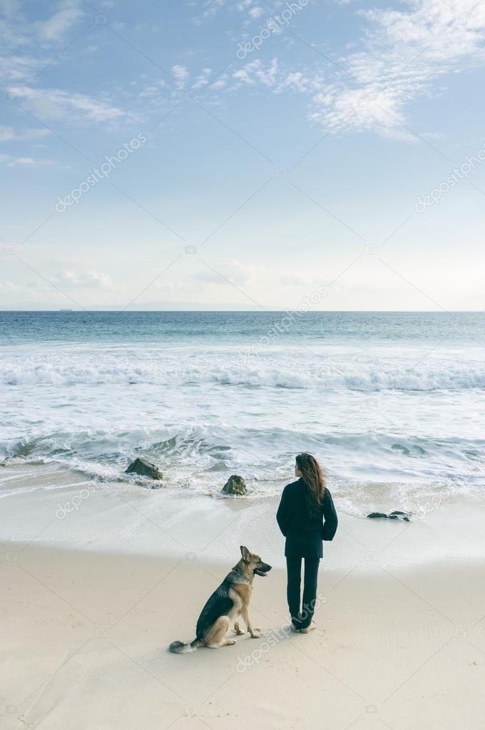 Woman with her dog at the beach