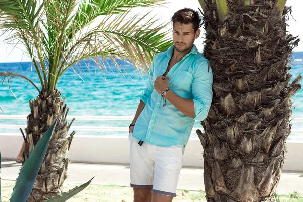 Handsome model in turquoise shirt posing — Stock Photo, Image