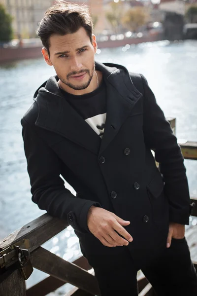 Young man in black coat — Stock Photo, Image