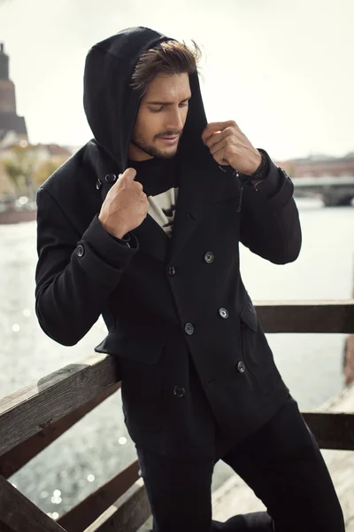 Young man in black coat — Stock Photo, Image