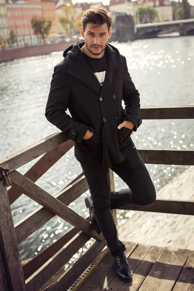 Young man in black coat — Stock Photo, Image