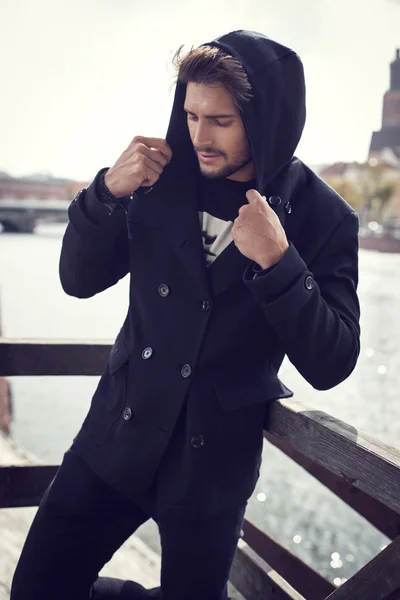 Young man in black coat — Stock Photo, Image