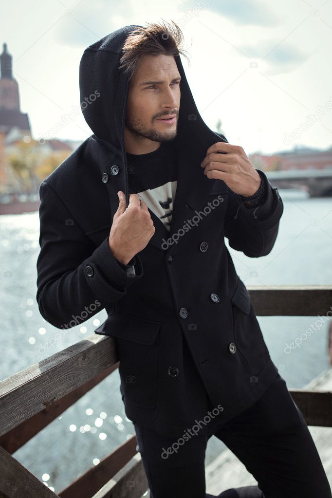 Young man in black coat