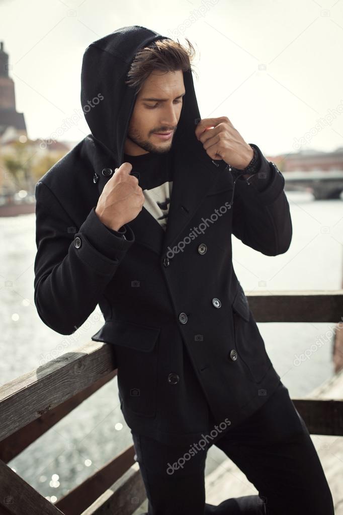 Young man in black coat