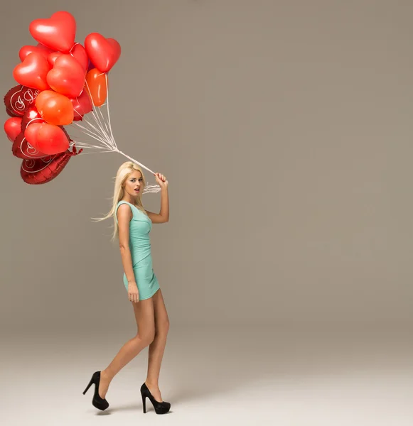 Cheerful woman with red balloons — Stock Photo, Image
