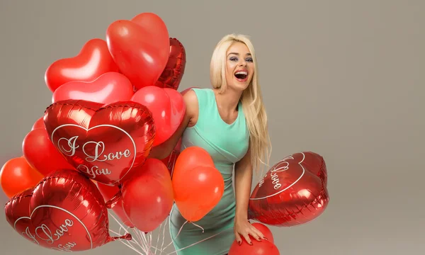 Cheerful woman with red balloons — Stock Photo, Image