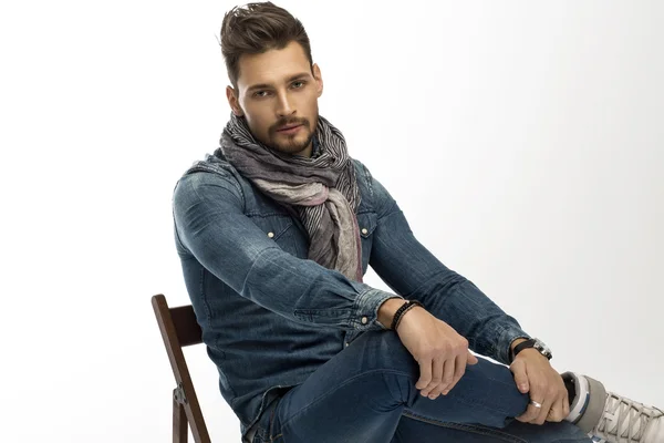 Handsome man sitting on wooden chair — Stock Photo, Image