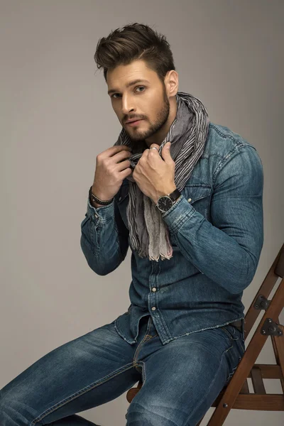 Handsome man sitting in chair — Stock Photo, Image