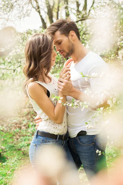 Couple touching each other in the garden — Stock Photo, Image