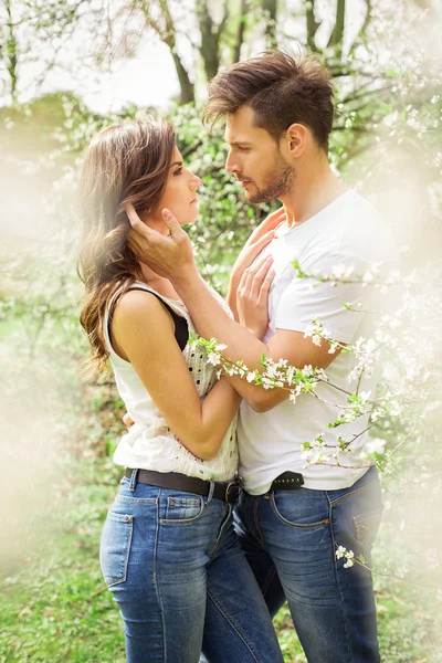Couple touching each other in the garden — Stock Photo, Image