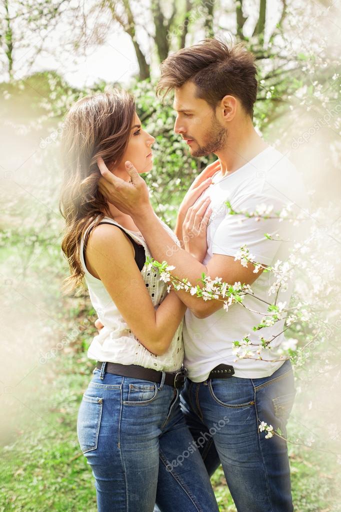 Couple touching each other in the garden