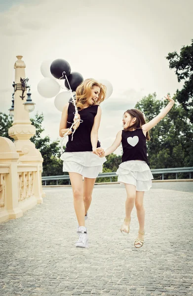 Mother with doughter having a fun with baloons — Stock Photo, Image