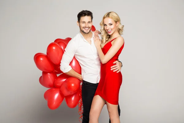 Valentine's photo of young loving couple with balloons — Stock Photo, Image