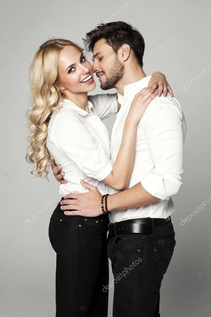 Handsome man kissing young beautiful blond woman