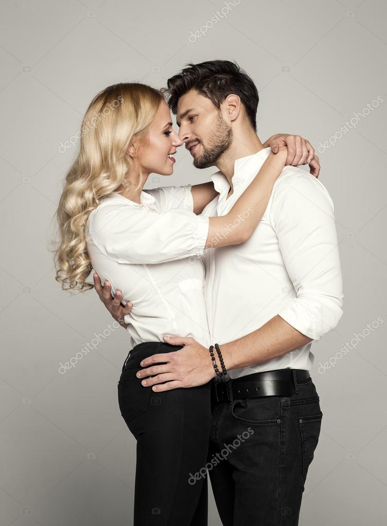 Handsome man kissing young beautiful blond woman